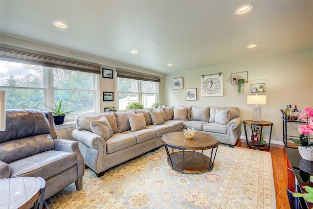 living room with recessed lighting, baseboards, and wood finished floors