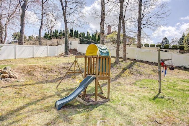 view of jungle gym with a yard and a fenced backyard