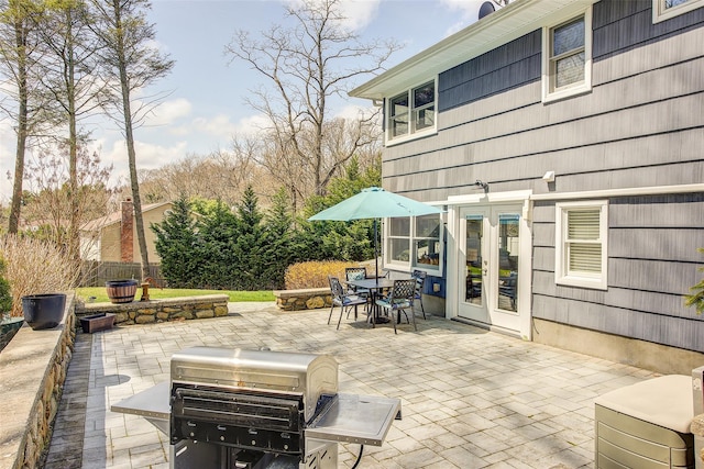 view of patio / terrace featuring fence, french doors, and outdoor dining area