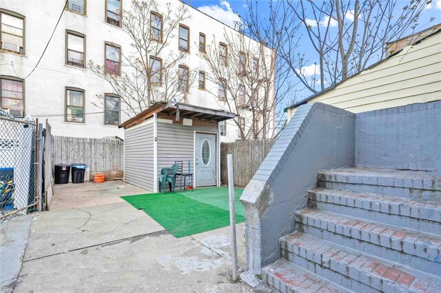 109-55 Lefferts Blvd, South Ozone Park, NY 11419 - exterior space featuring an outdoor structure, a fenced backyard, and a shed