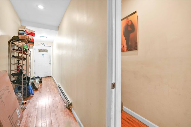 109-55 Lefferts Blvd, South Ozone Park, NY 11419 - hallway with baseboards, a baseboard radiator, and hardwood / wood-style flooring