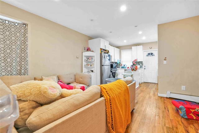 109-55 Lefferts Blvd, South Ozone Park, NY 11419 - living room with recessed lighting, a baseboard radiator, light wood-style flooring, and baseboards