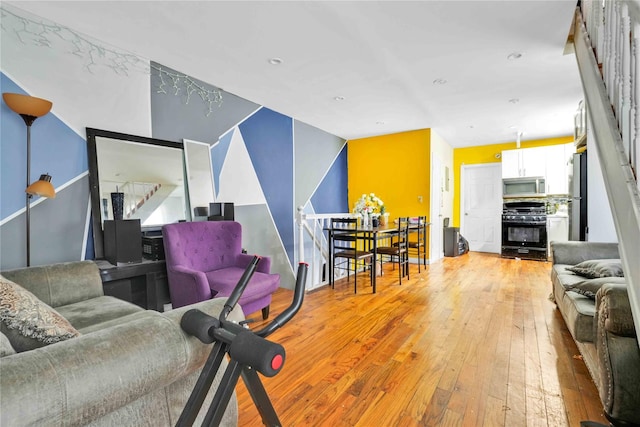 109-55 Lefferts Blvd, South Ozone Park, NY 11419 - living room featuring light wood-type flooring, recessed lighting, and stairway