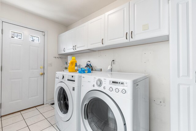 clothes washing area with independent washer and dryer, light tile patterned flooring, and cabinet space