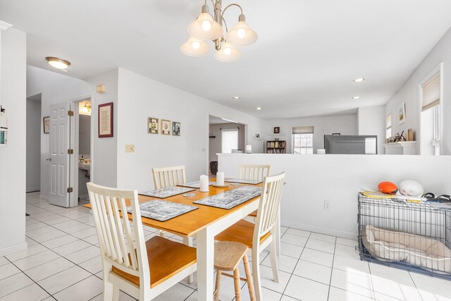 dining area featuring recessed lighting, baseboards, an inviting chandelier, and light tile patterned floors