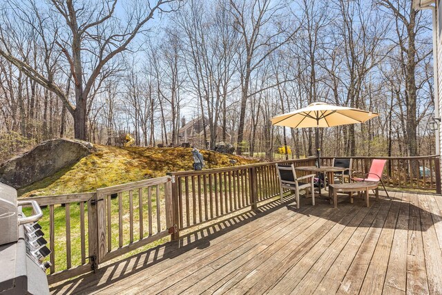 wooden deck featuring outdoor dining space