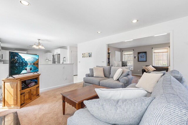 living room with light colored carpet, baseboards, a notable chandelier, and recessed lighting