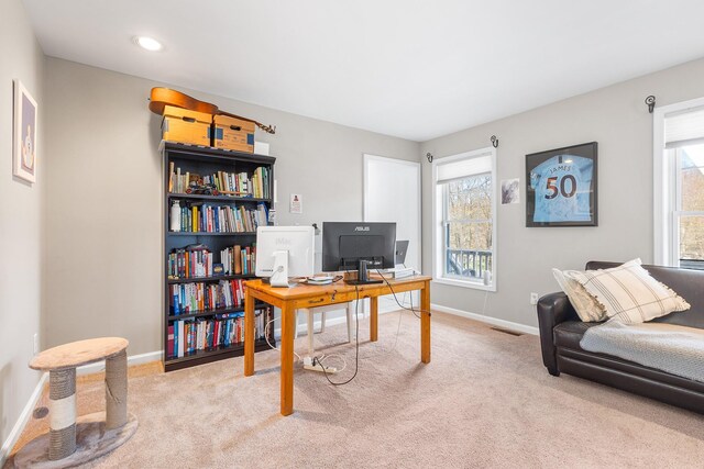 carpeted office with baseboards and visible vents