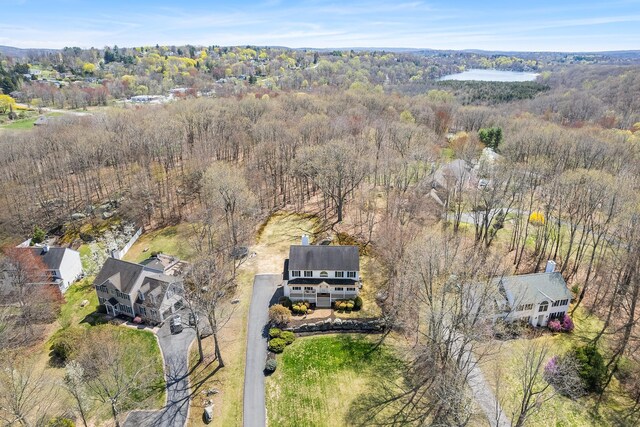bird's eye view with a wooded view