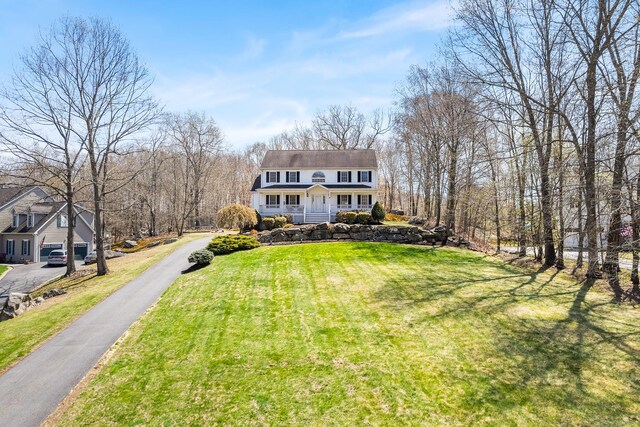 view of front of house with a porch and a front lawn