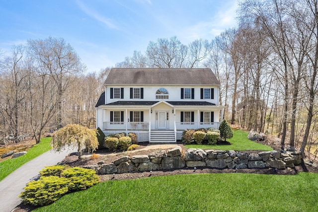 8 Killian Ln, Brewster, NY 10509 - colonial-style house with a porch, a front lawn, and roof with shingles