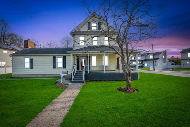 view of front of property featuring a porch, a yard, a chimney, and a shingled roof