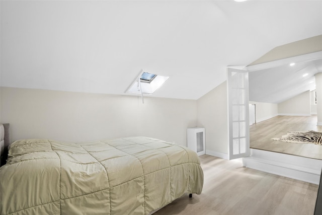 120 Loomis Ave, Yonkers, NY 10704 - bedroom with a skylight, wood finished floors, lofted ceiling, baseboards, and recessed lighting