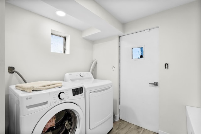 120 Loomis Ave, Yonkers, NY 10704 - laundry area with washing machine and dryer, light wood-style floors, and baseboards
