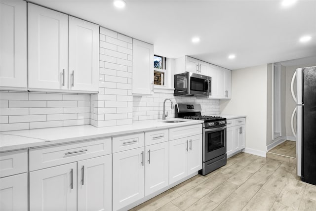 120 Loomis Ave, Yonkers, NY 10704 - kitchen featuring stainless steel appliances, a sink, white cabinetry, recessed lighting, and backsplash