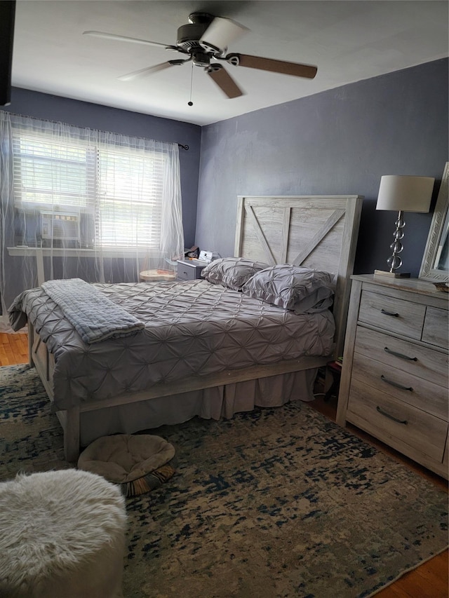 bedroom with a ceiling fan and wood finished floors