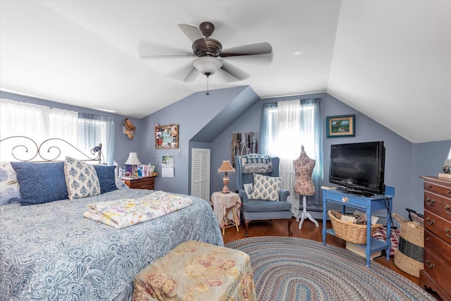 bedroom featuring wood finished floors, multiple windows, vaulted ceiling, and ceiling fan
