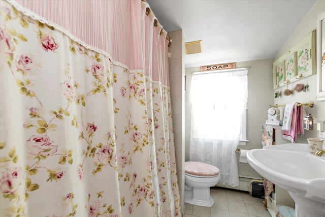 full bath with tile patterned flooring, toilet, and curtained shower