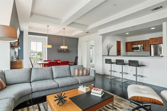 living area with dark wood-style flooring, recessed lighting, baseboards, visible vents, and coffered ceiling