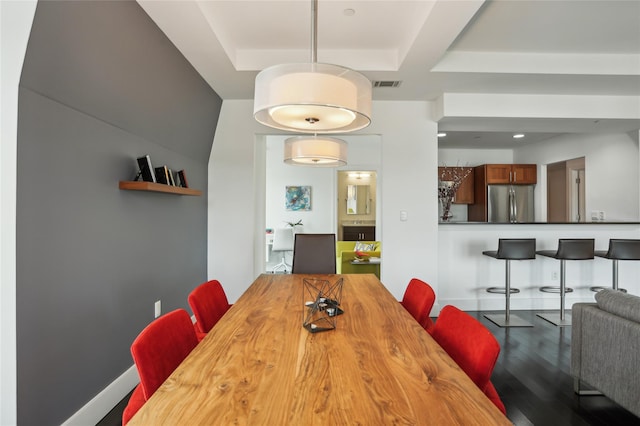 dining area featuring visible vents and wood finished floors