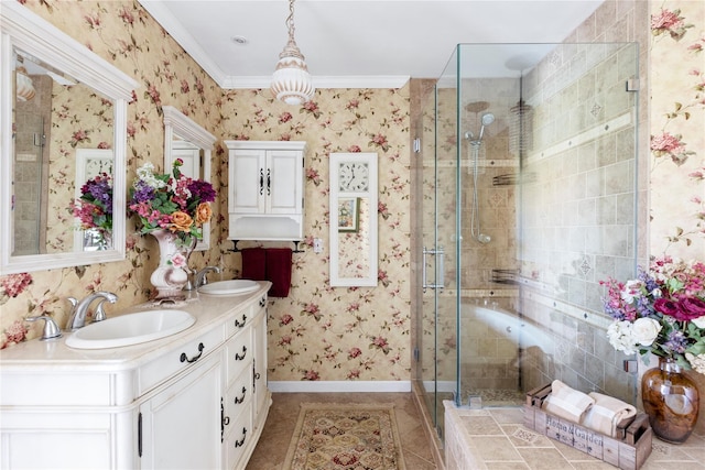 bathroom with a sink, a stall shower, and wallpapered walls