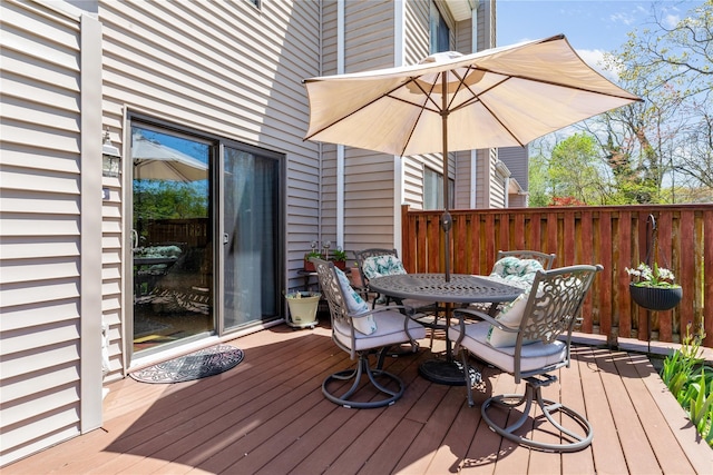 wooden deck featuring outdoor dining area