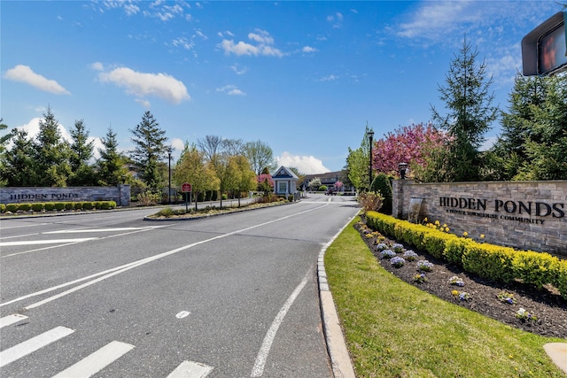 view of street featuring traffic signs and curbs