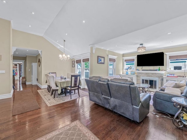 565 Baldwin Ave, North Baldwin, NY 11510 - living room featuring a glass covered fireplace, wood finished floors, a notable chandelier, and vaulted ceiling