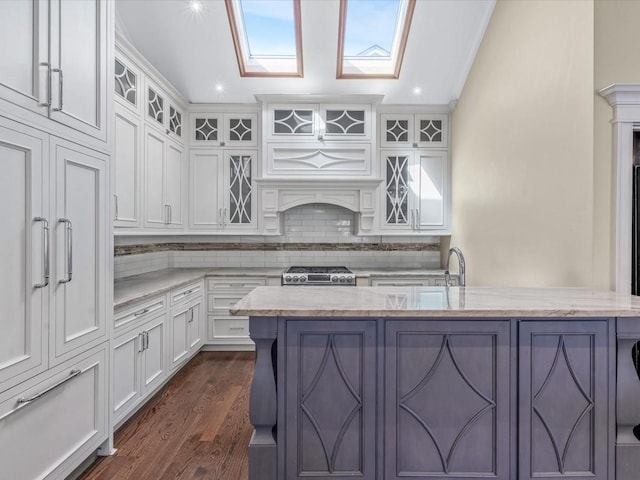 565 Baldwin Ave, North Baldwin, NY 11510 - kitchen featuring white cabinetry, stove, light stone countertops, and tasteful backsplash