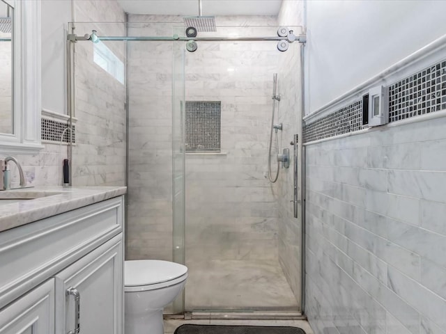565 Baldwin Ave, North Baldwin, NY 11510 - bathroom with vanity, a shower stall, toilet, and tile walls