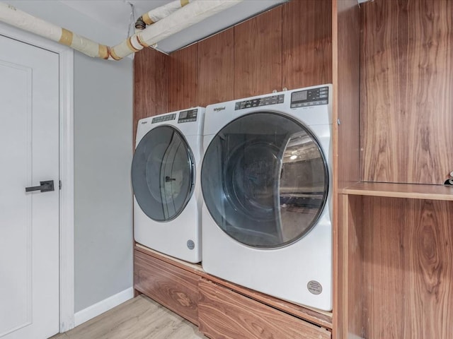 565 Baldwin Ave, North Baldwin, NY 11510 - clothes washing area with baseboards, laundry area, light wood finished floors, and independent washer and dryer