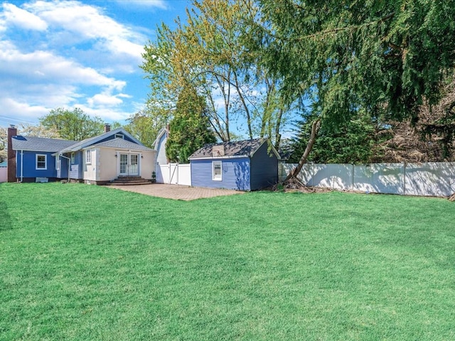 565 Baldwin Ave, North Baldwin, NY 11510 - view of yard with an outdoor structure, a fenced backyard, a patio area, and french doors