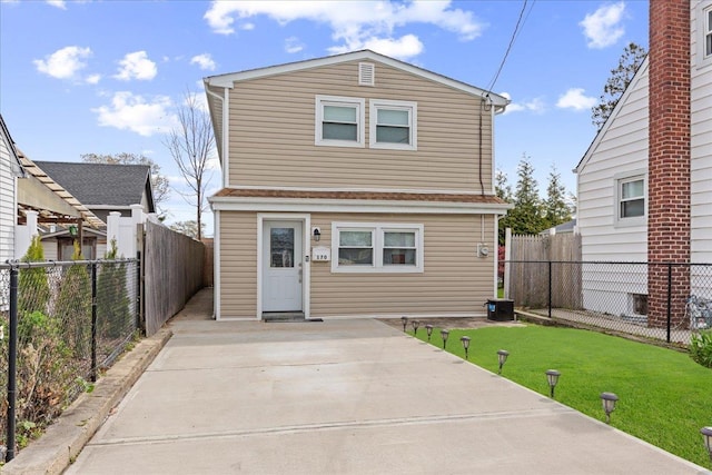 back of house with a yard, a patio area, and a fenced backyard