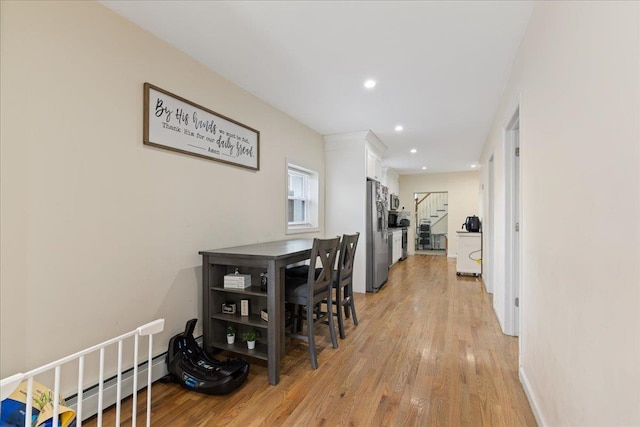 hallway featuring stairway, light wood-type flooring, recessed lighting, and a baseboard heating unit