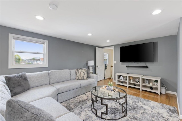 living room featuring recessed lighting, light wood finished floors, and baseboards