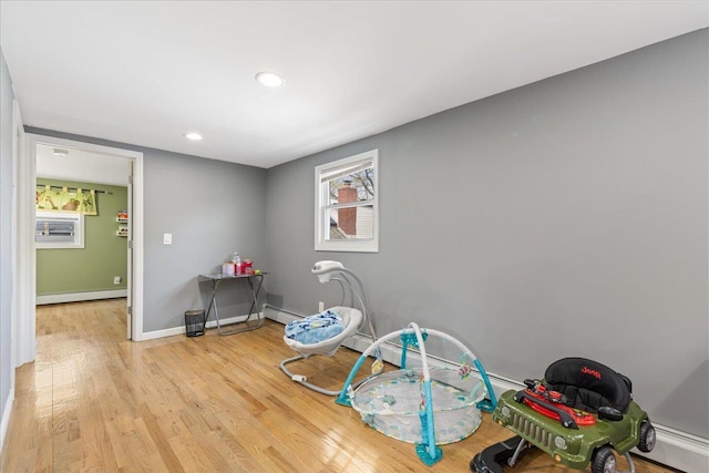 game room with recessed lighting, light wood-style flooring, baseboard heating, and baseboards