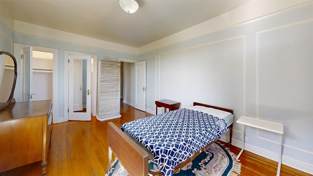 bedroom featuring baseboards and wood finished floors