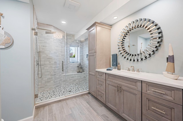 full bath featuring vanity, recessed lighting, wood finished floors, and a stall shower