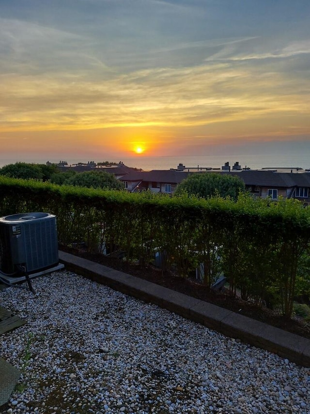 yard at dusk with cooling unit