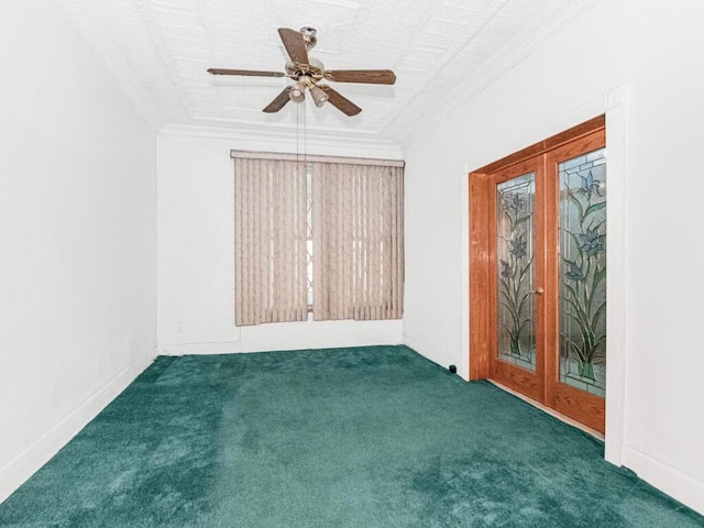 carpeted spare room with crown molding, a ceiling fan, french doors, and baseboards