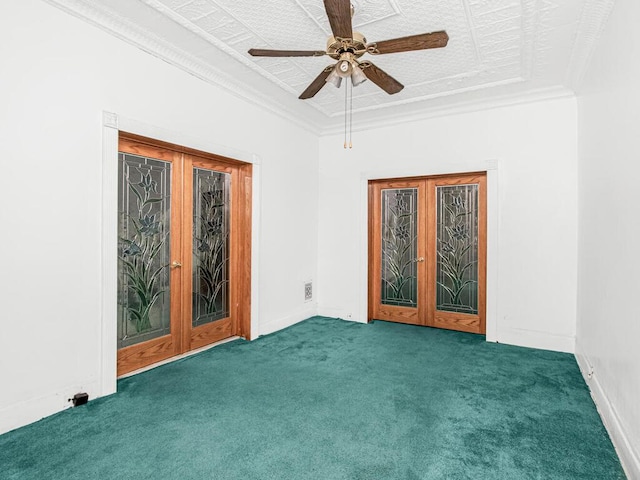 carpeted spare room featuring french doors, ceiling fan, ornamental molding, and baseboards