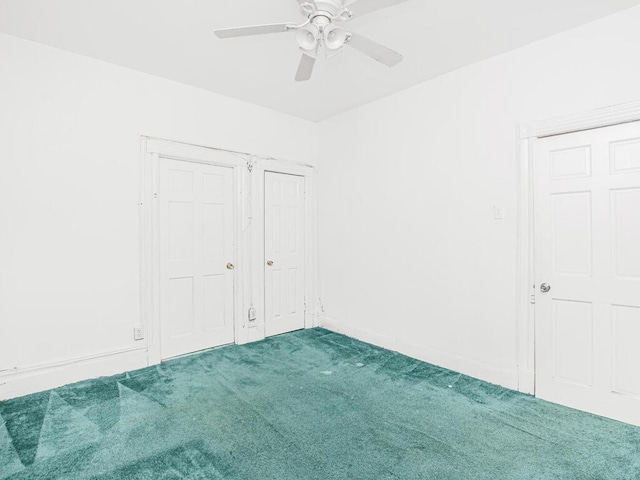unfurnished bedroom with baseboards, a ceiling fan, and carpet