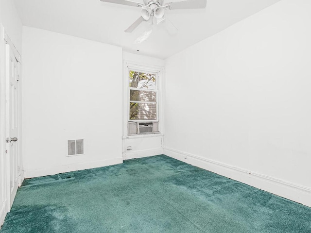 unfurnished room with visible vents, a ceiling fan, baseboards, carpet, and cooling unit