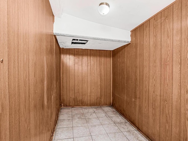 spare room with wooden walls and light tile patterned floors