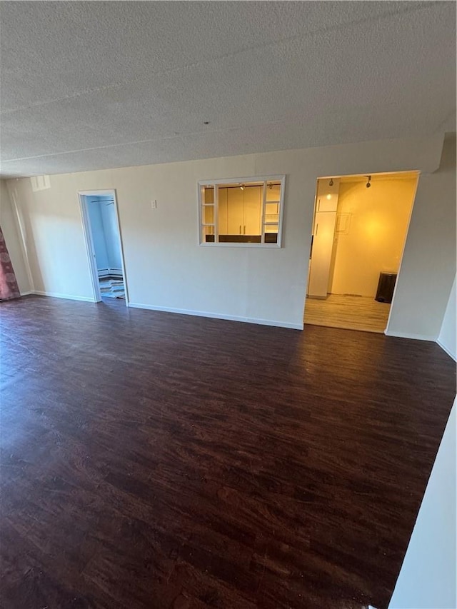 35 Park Ave Unit 1D, Suffern, NY 10901 - unfurnished room featuring baseboards, a textured ceiling, and wood finished floors