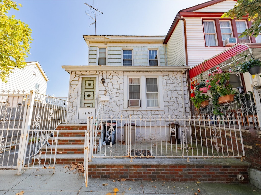 view of front of property with a gate, cooling unit, and a fenced front yard