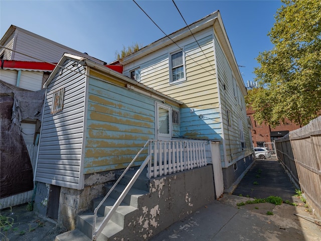 view of property exterior featuring fence