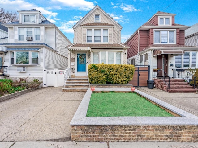 7846 64th Pl, Glendale, NY 11385 - american foursquare style home featuring fence, a gate, and a wall unit AC
