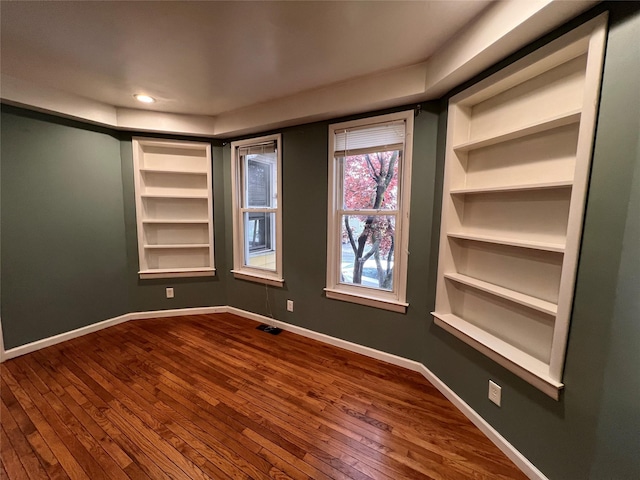 57 Prince St, Middletown, NY 10940 - empty room featuring baseboards, recessed lighting, dark wood-style flooring, and built in shelves