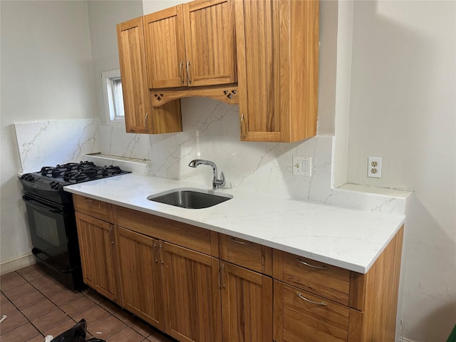 57 Prince St, Middletown, NY 10940 - kitchen featuring a sink, black gas range oven, brown cabinetry, and tasteful backsplash